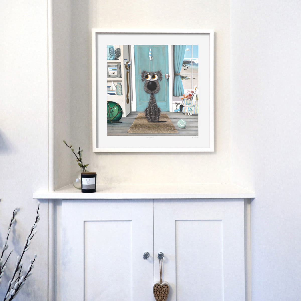 Framed artwork of a dog on a shelf with decorative items.
