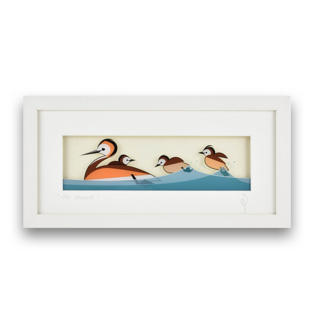A framed art print depicting a family of grebes swimming in stylised water, with a wide white frame and mat on a clean white background.