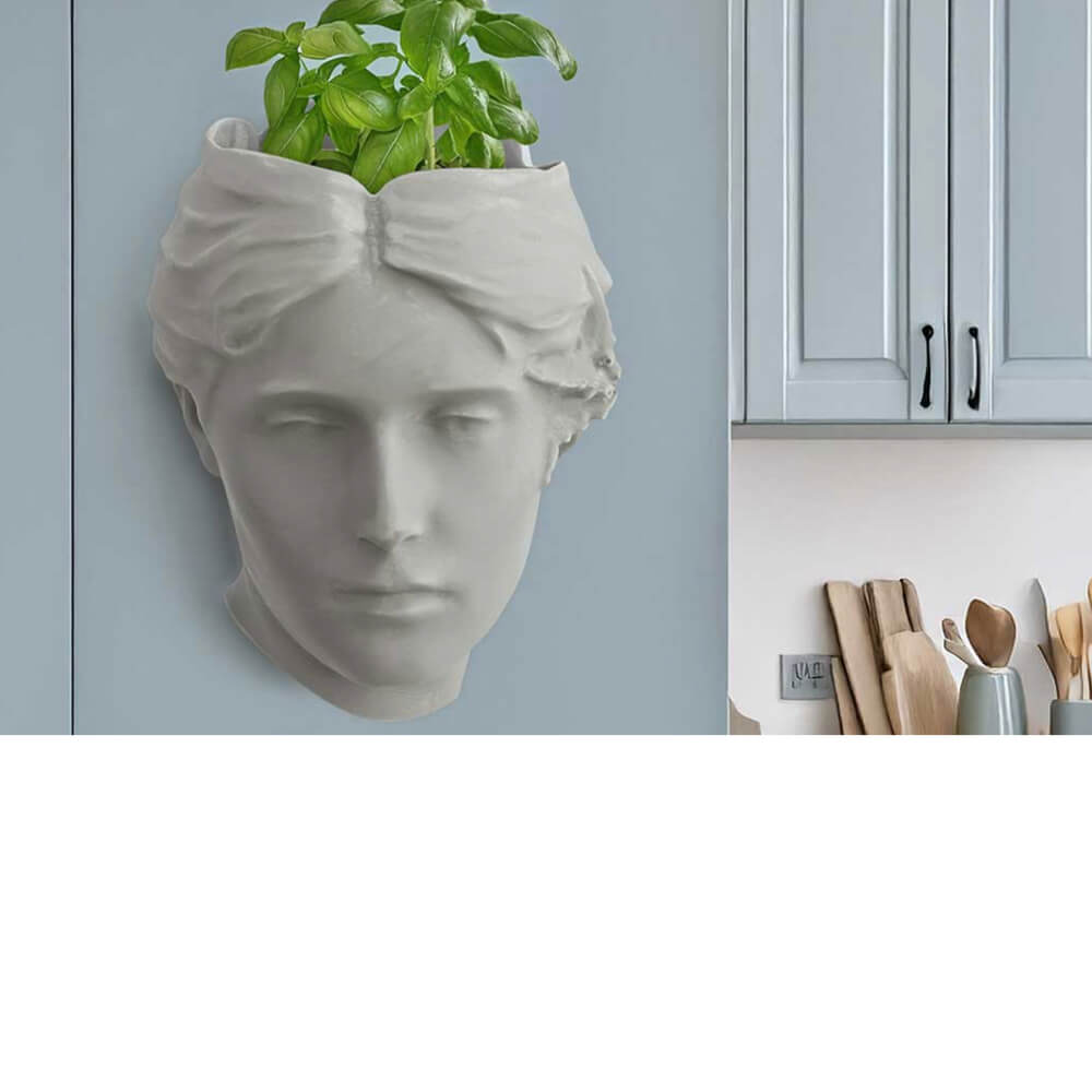 Angel of Atlantis wall planter in soft sage with herbs and succulents, sculptural stone-effect wall-mounted planter for kitchen or living room