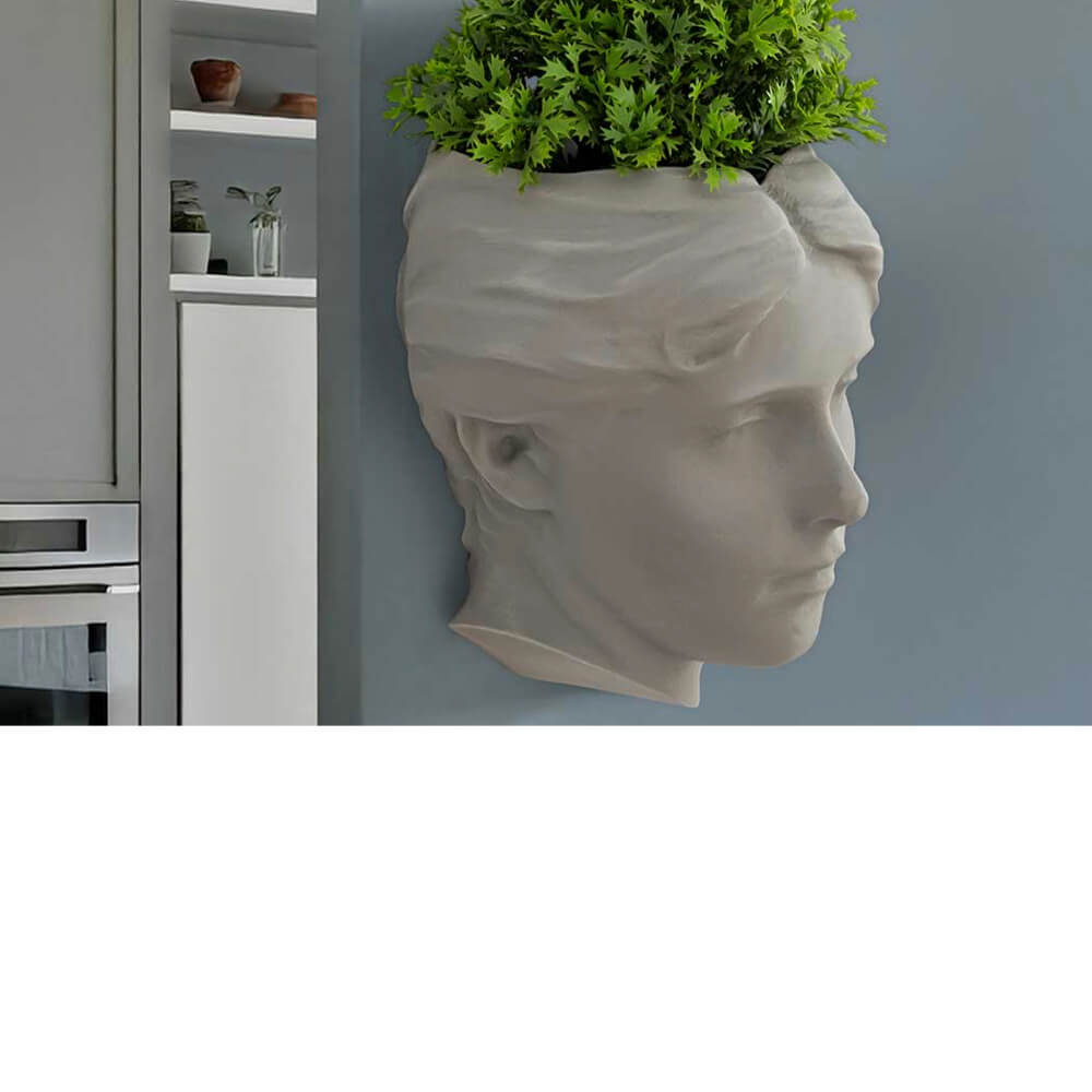 Angel of Atlantis wall planter in soft sage with herbs and succulents, sculptural stone-effect wall-mounted planter for kitchen or living room