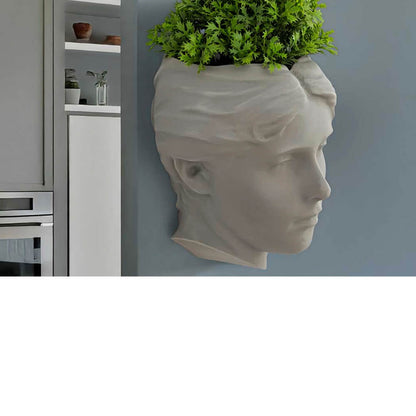 Angel of Atlantis wall planter in soft sage with herbs and succulents, sculptural stone-effect wall-mounted planter for kitchen or living room