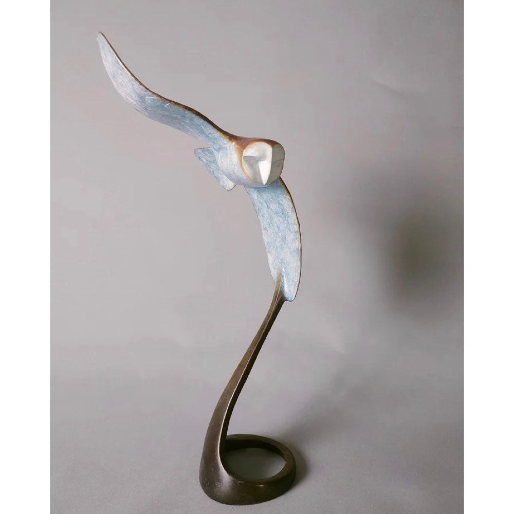 Abstract sculpture of a bird in flight on a plain background
