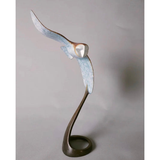 Abstract sculpture of a bird in flight on a plain background