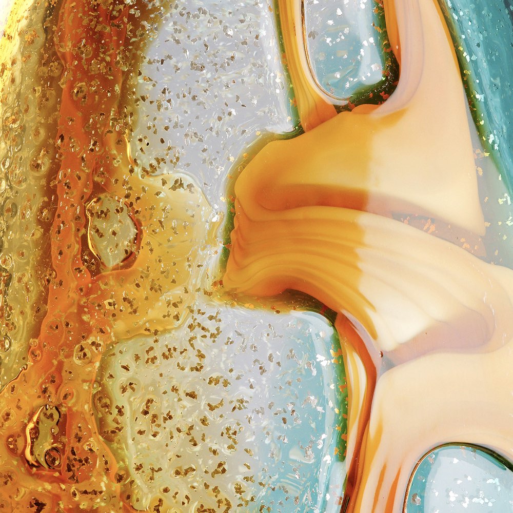 Close-up of a textured surface with gold, white, and blue colors
