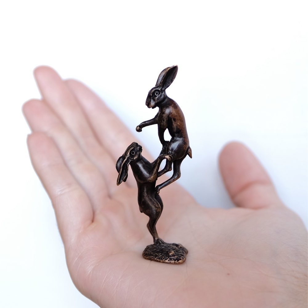 Hares boxing in bronze.