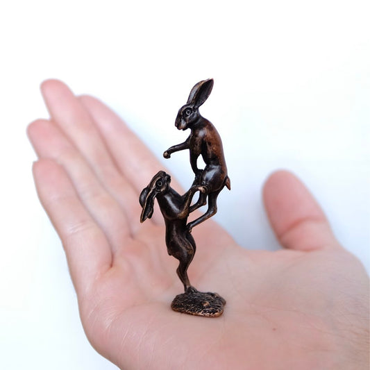Hares boxing in bronze.