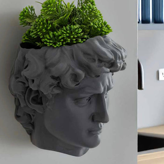 David wall planter in cool grey with trailing plants, sculptural stone-effect wall-mounted planter for herbs and succulents