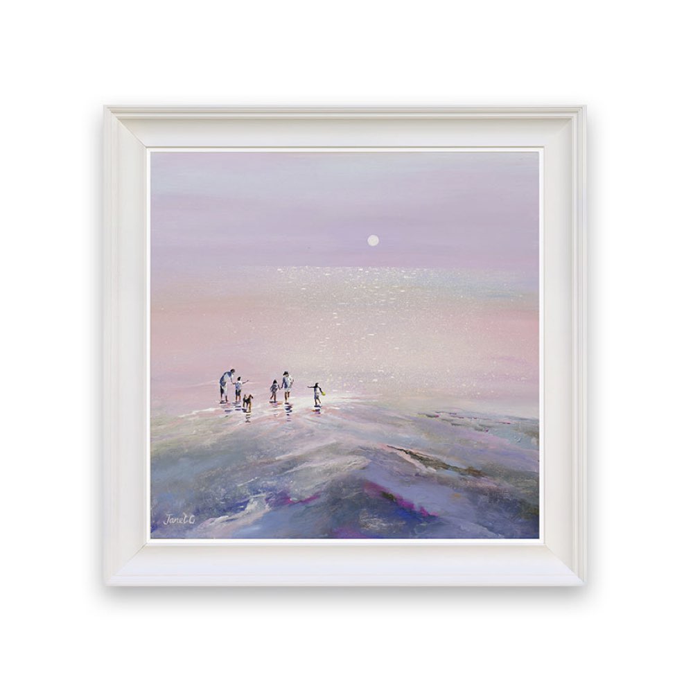 Framed artwork of a group of people on a beach at sunset with a white frame.