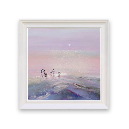 Framed artwork of a group of people on a beach at sunset with a white frame.
