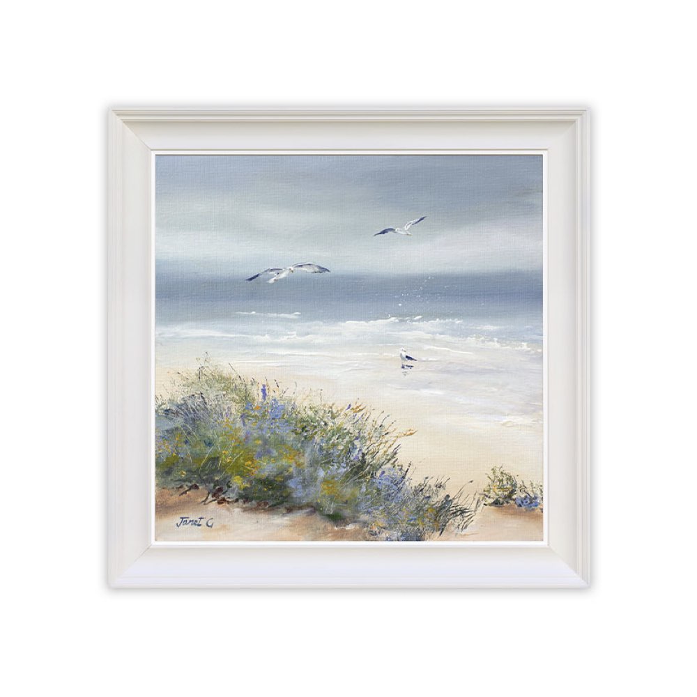 Framed artwork of a beach scene with seagulls and vegetation.