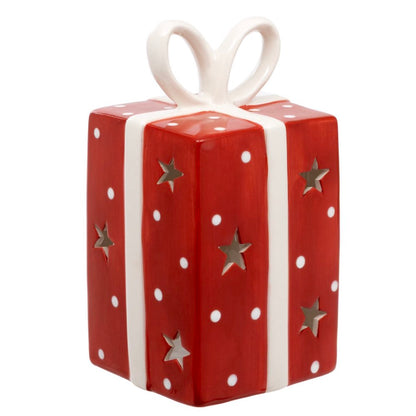 Red gift box with white polka dots and silver stars, tied with a white ribbon on a white background.
