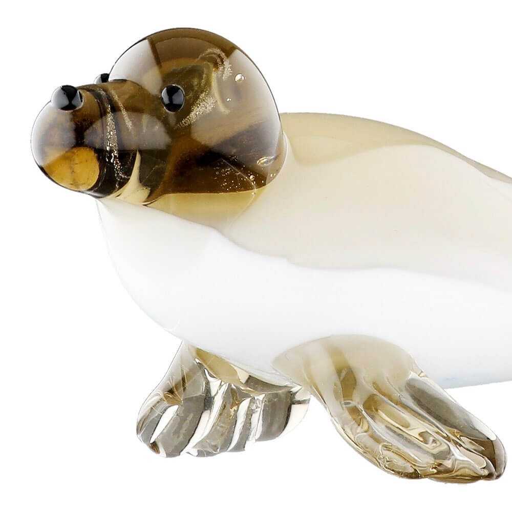 Glass sculpture of a seal on a white background