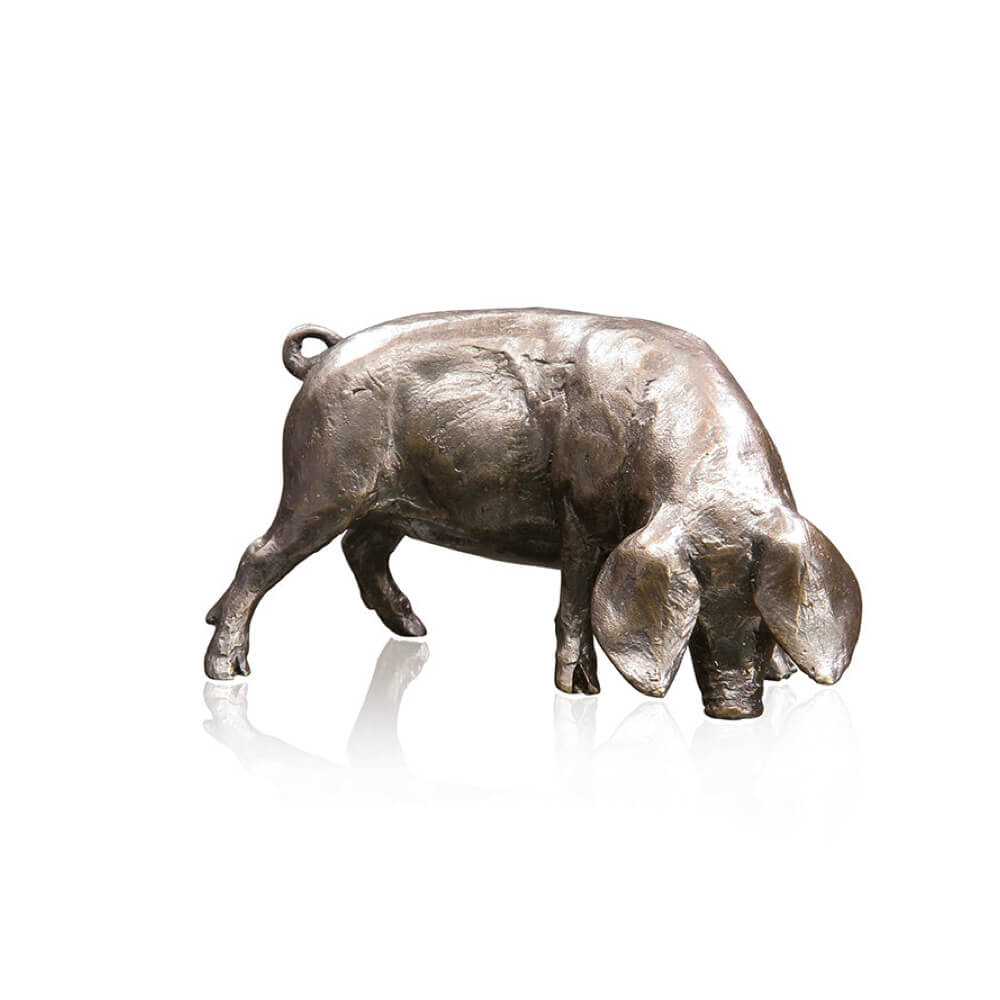 A solid bronze sculpture of a Gloucester Old Spot pig on a white background.