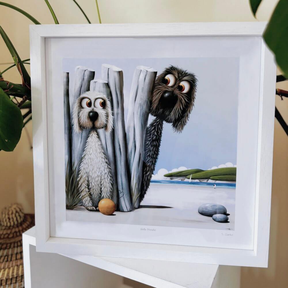 Framed artwork of two dogs peeking from behind a curtain with a scenic background.
