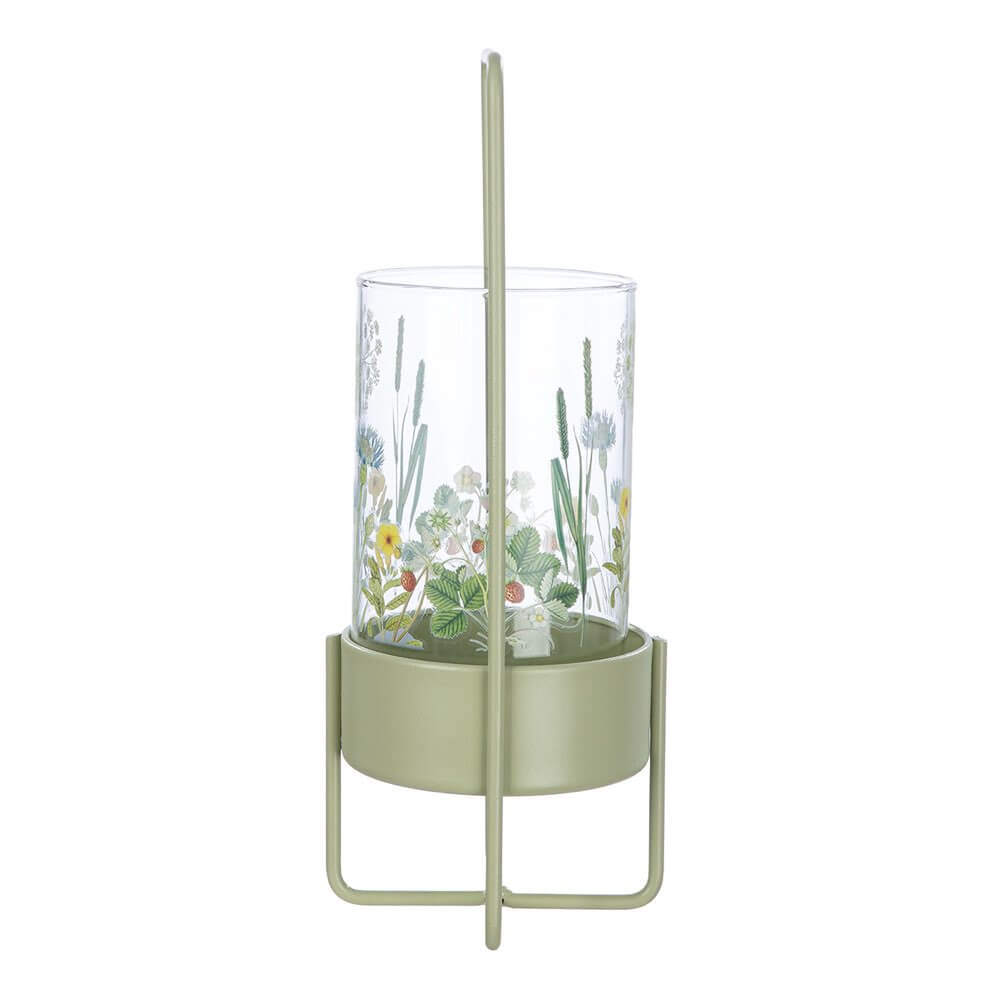Glass planter with green metal stand on a white background