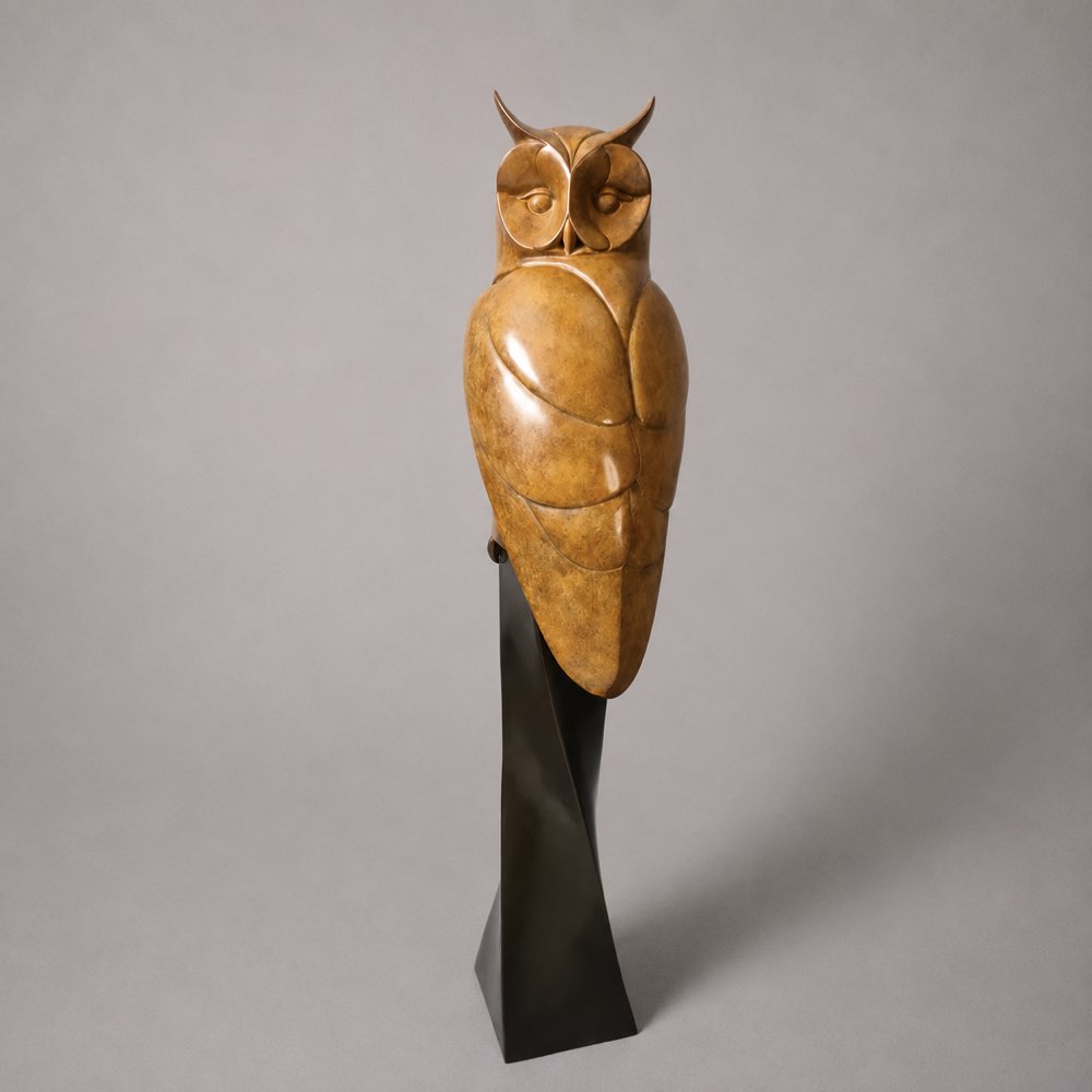 Beautiful bronze owl perched on a plinth