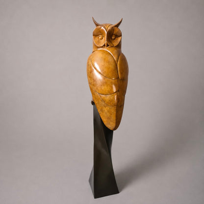 Beautiful bronze owl perched on a plinth