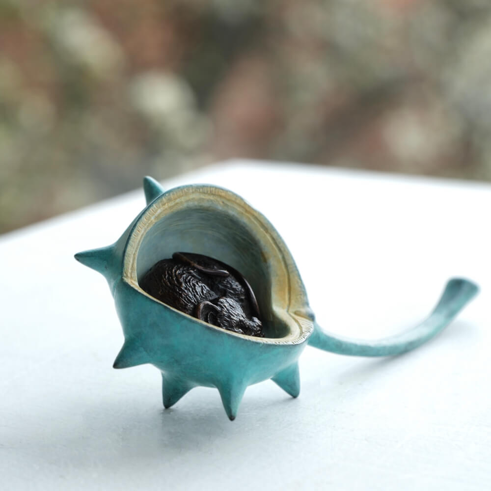 Bronze mouse nestled in a turquoise patina bronze conker.
