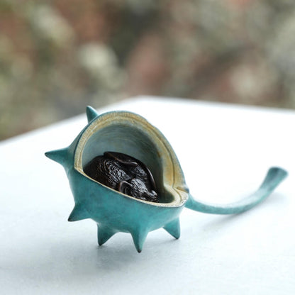 Bronze mouse nestled in a turquoise patina bronze conker.