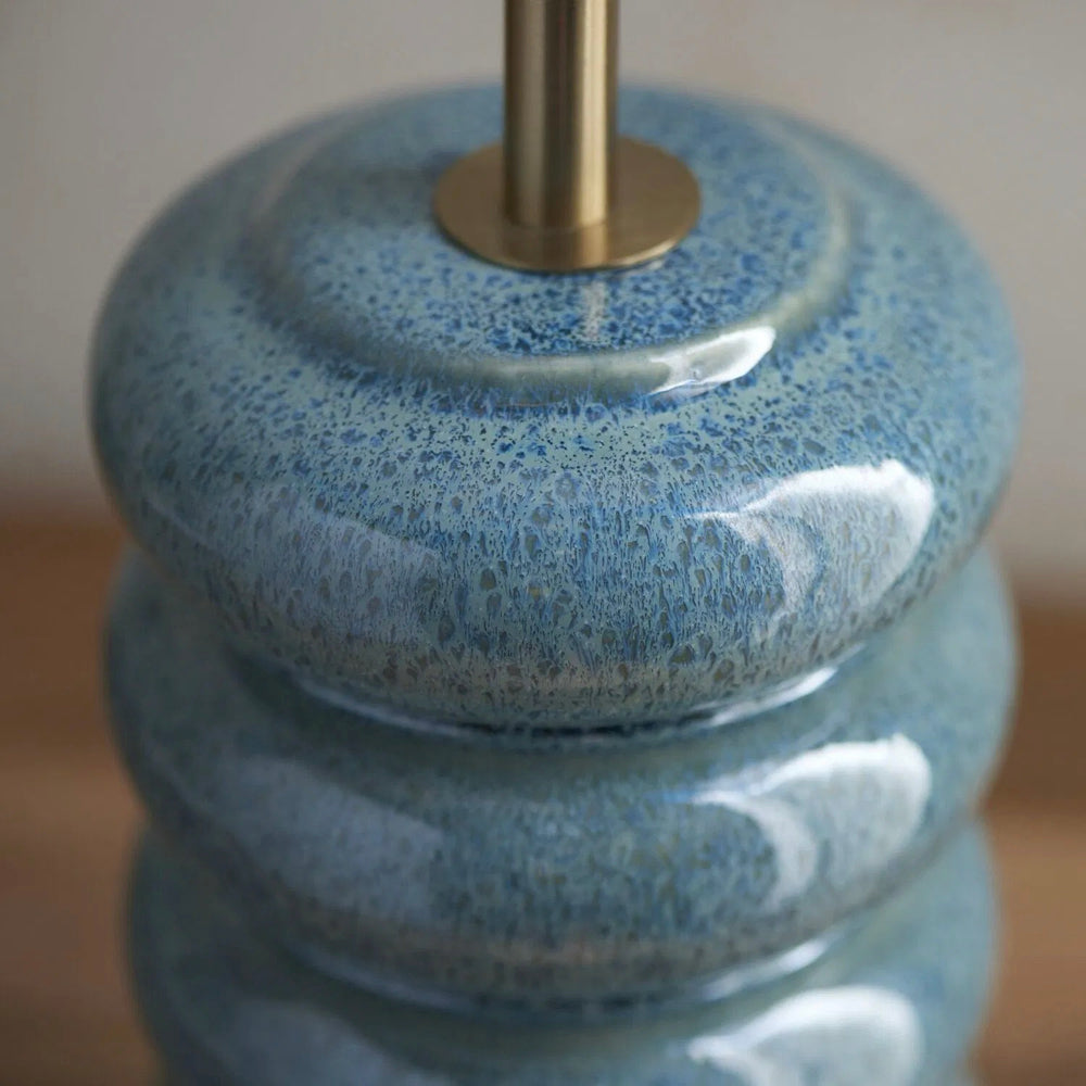 Ocean spray ceramic table lamp with marlin blue Ikat patterned tapered shade for bedroom and lounge interiors