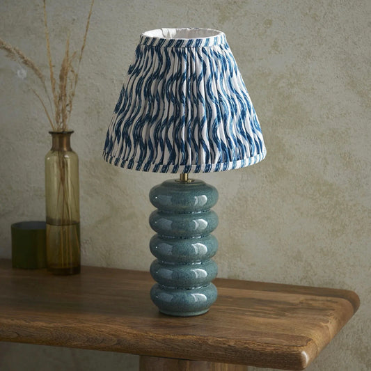 Ocean spray ceramic table lamp with marlin blue Ikat patterned tapered shade for bedroom and lounge interiors