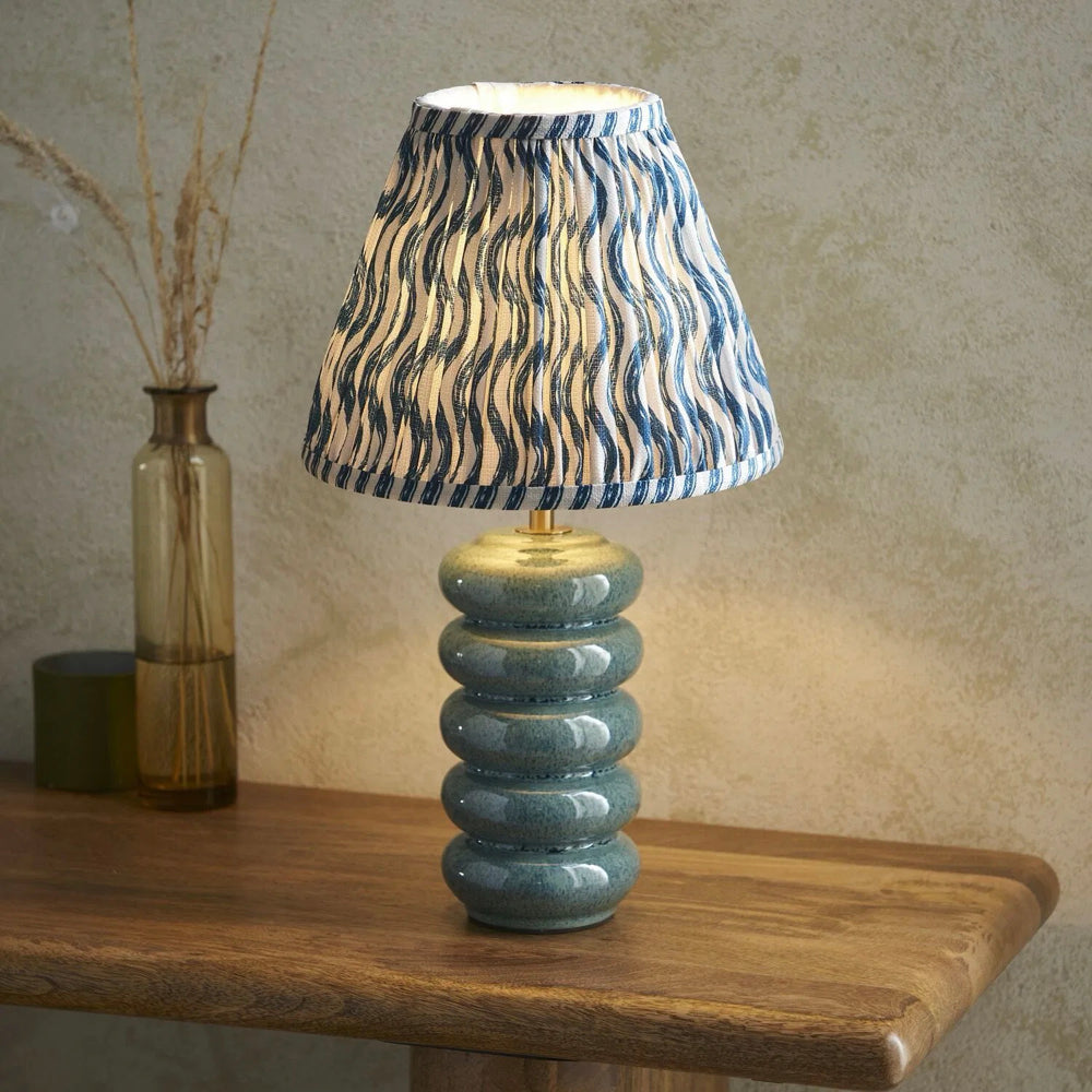 Ocean spray ceramic table lamp with marlin blue Ikat patterned tapered shade for bedroom and lounge interiors
