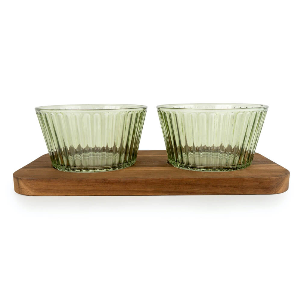 Two green glass bowls on a wooden stand against a white background