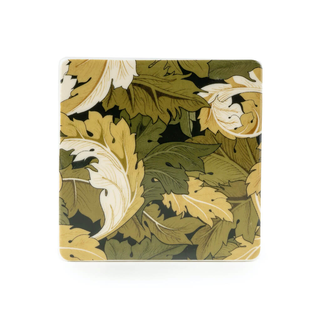 Floral patterned coaster with green and yellow leaves on a white background