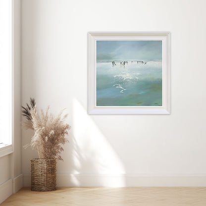 Framed artwork of a beach scene.