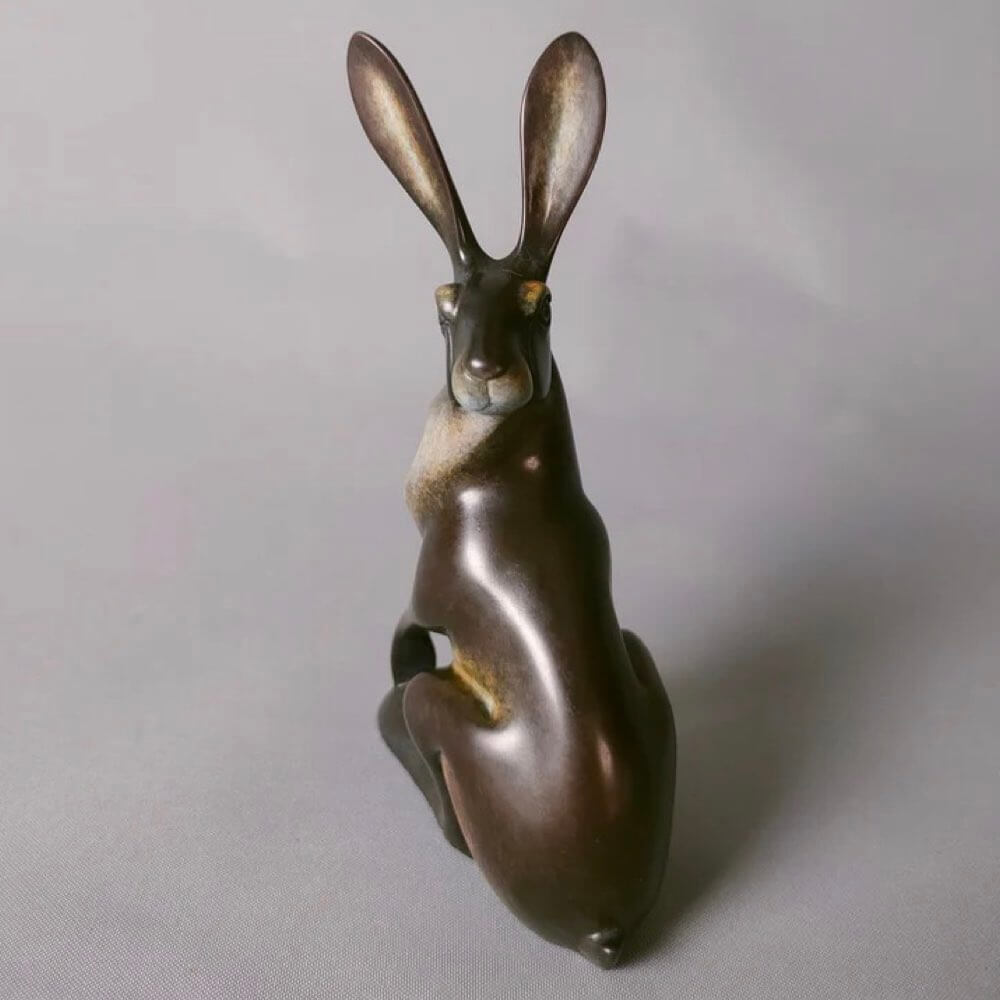 Bronze sculpture of a turning hare.