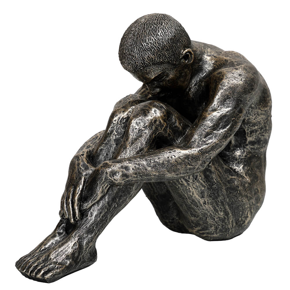 The Contemplating Man Sculpture in dark bronze-effect finish, seated male figure with head bowed and arms around knees