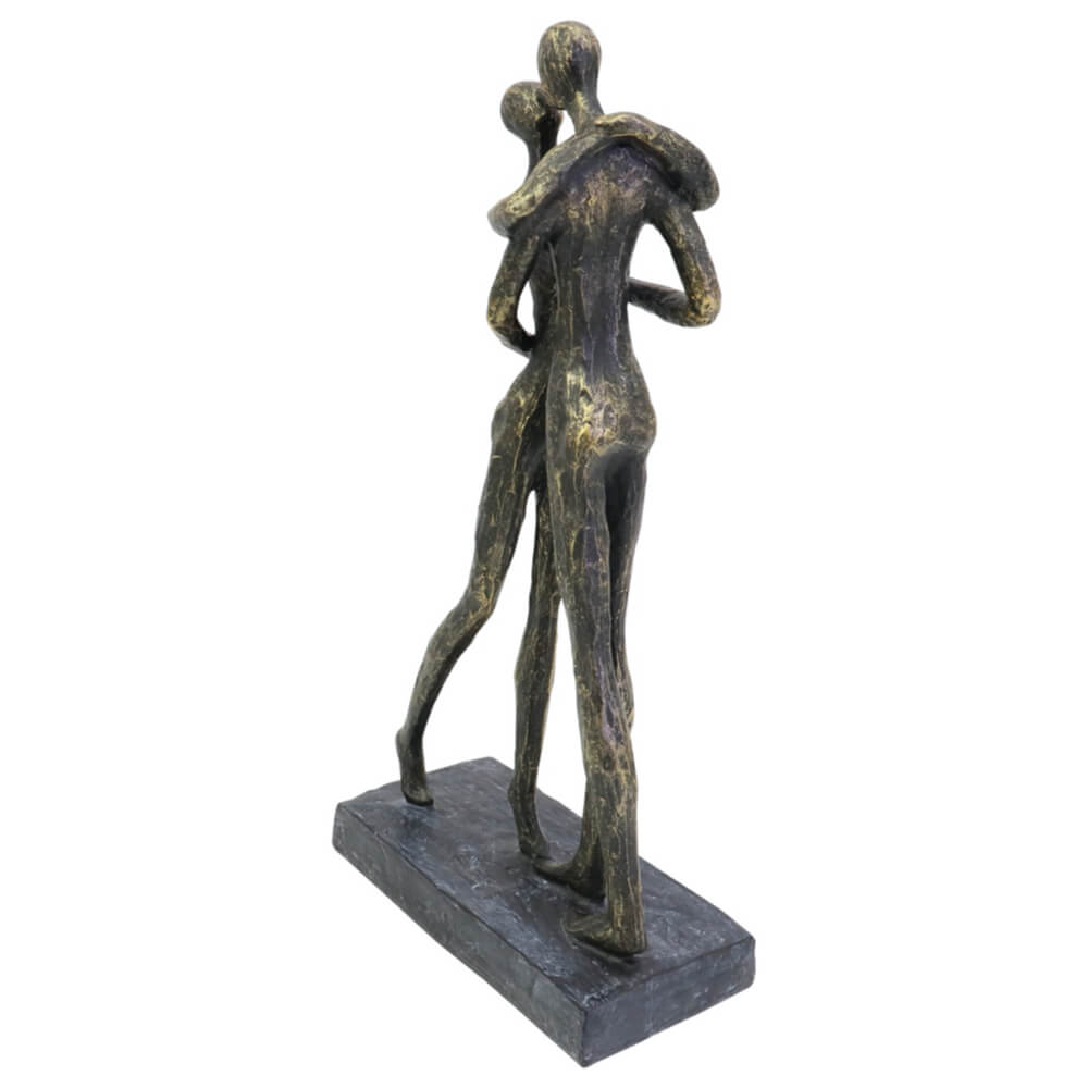 Bronze sculpture of two people embracing on a white background