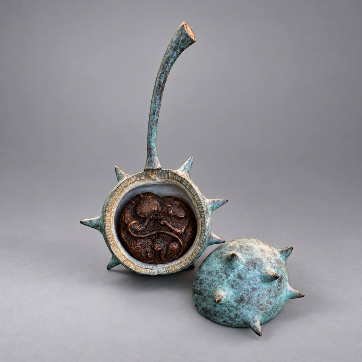 Two Mice in a Conker bronze sculpture by David Meredith, showing two curled mice inside a verdigris shell with the removable lid alongside.