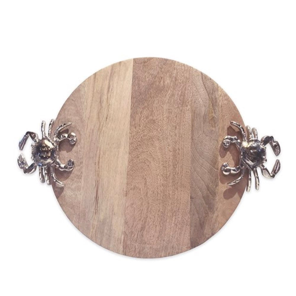 Wooden round cutting board with metal crab handles on a white background