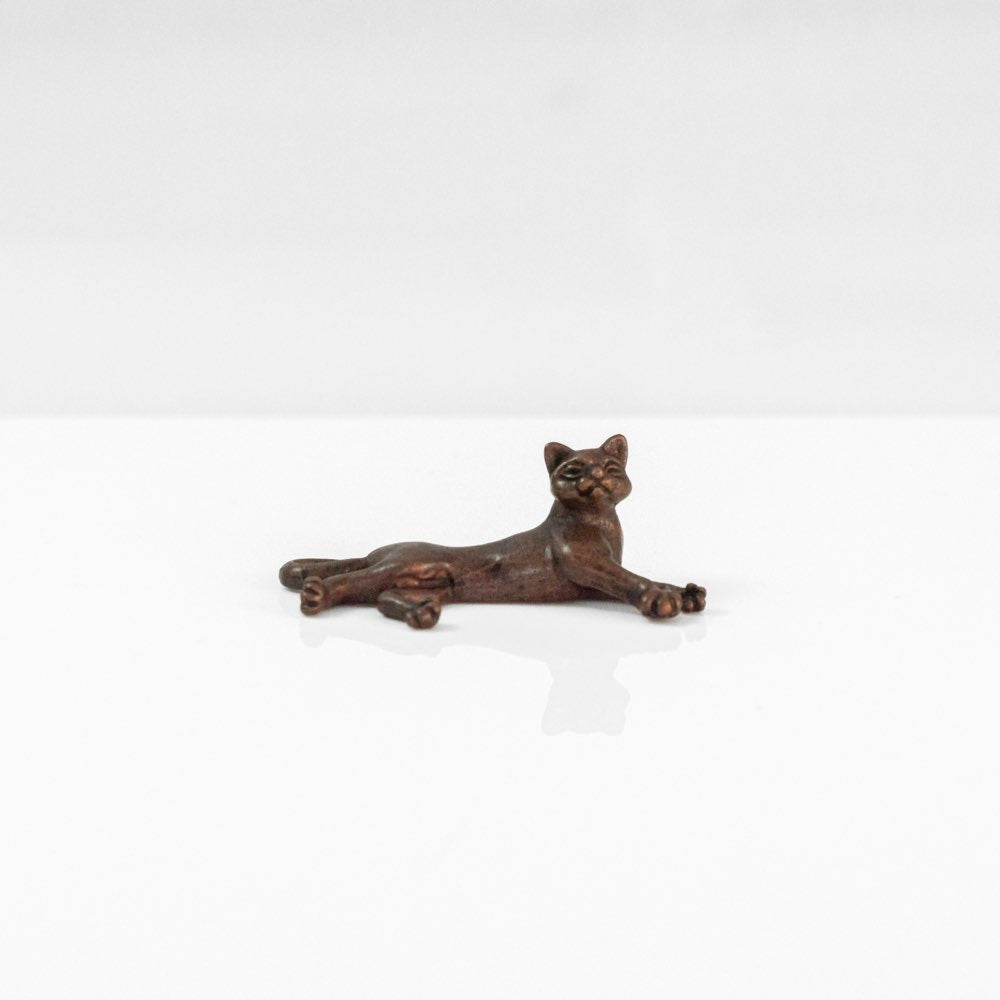 Miniature bronze laying cat 