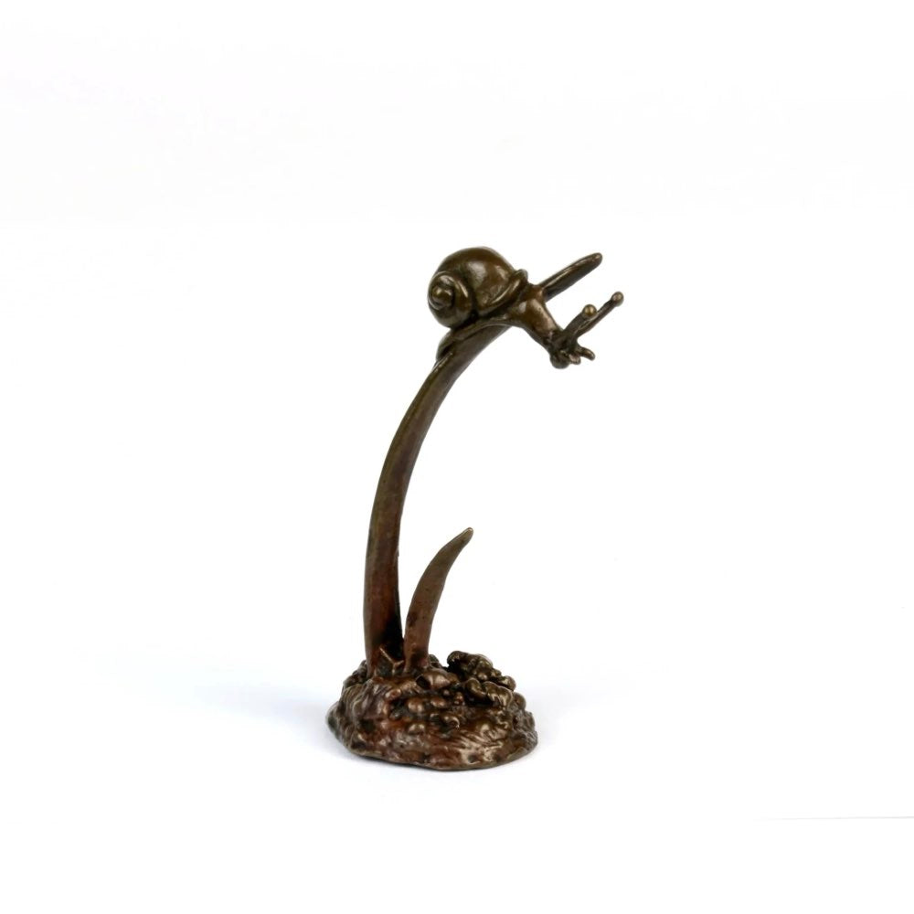 A small bronze figurine of a snail clinging to a curved stem. 