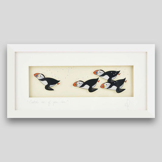 Framed print of puffins diving underwater 